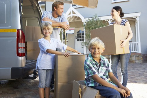 Removal team handling furniture for a house move in Barnet